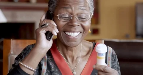 Caregiver helping elderly woman at home